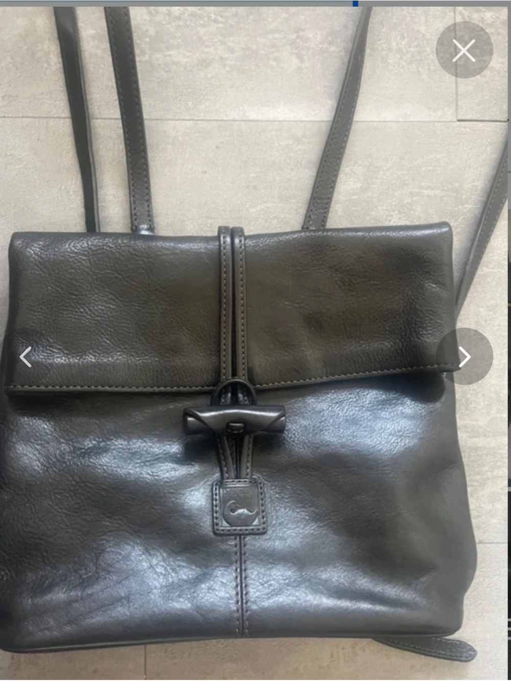 Dooney & Burke black leather backpack with red lining. High quality & timeless